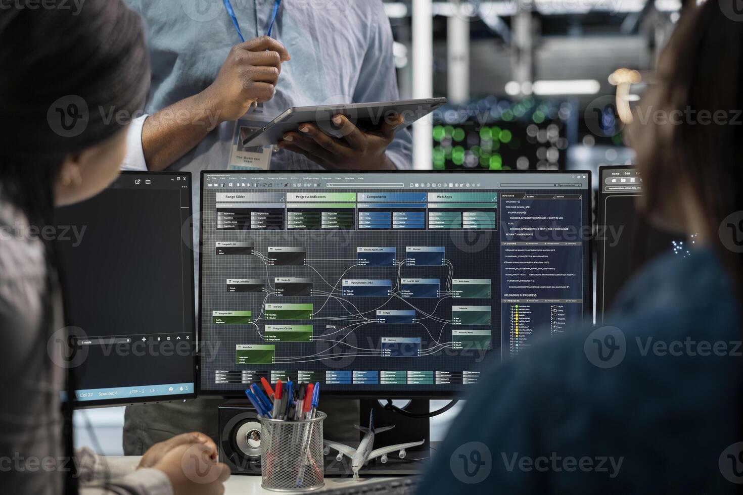 Close up of data center programmers using PC to visualize artificial intelligence neural networks. Server farm IT experts looking at monitor, working together to oversee AI systems photo