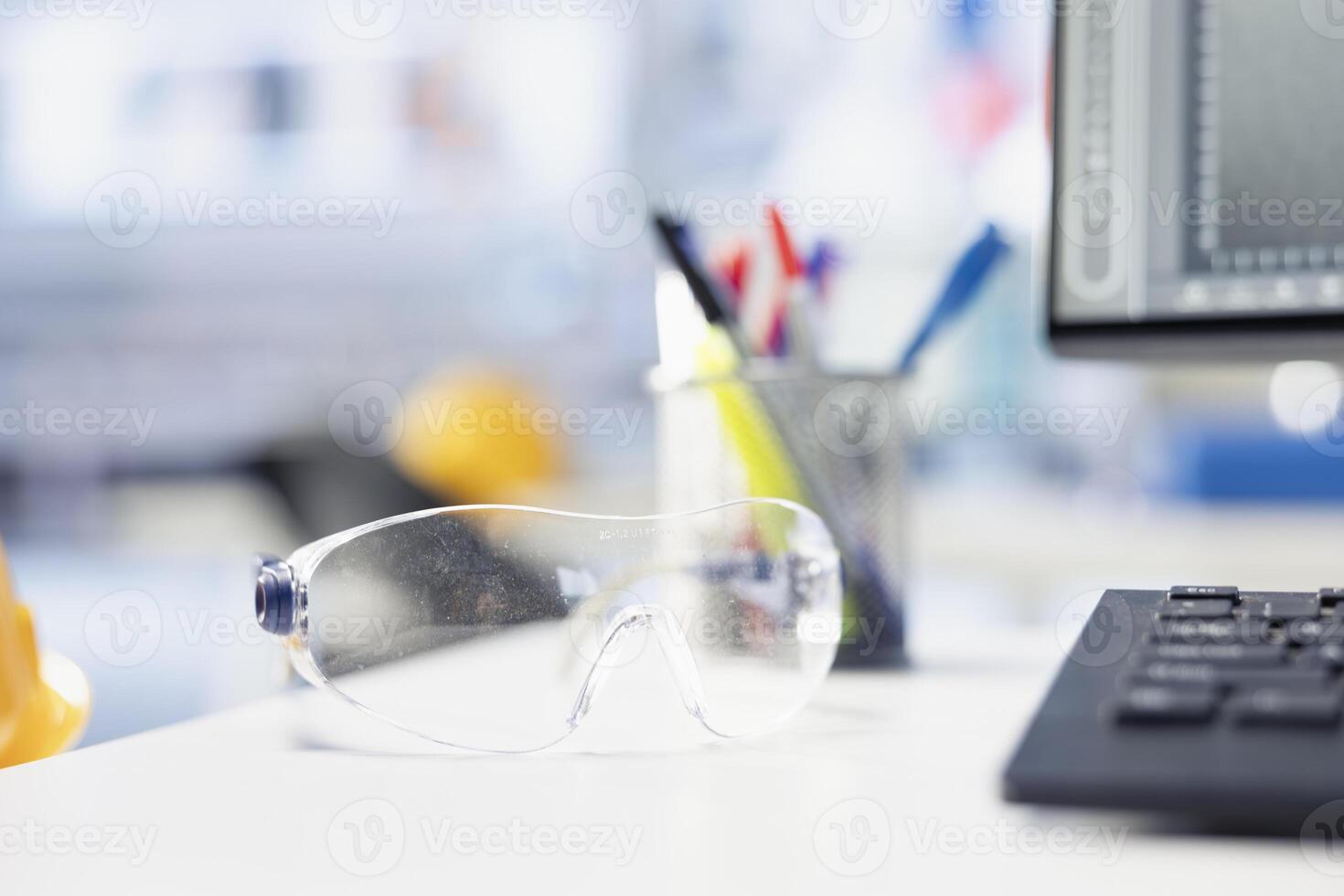 Stationary items on desk in photovoltaics factory engineering office with solar panels assembly processes. Close up of objects on desk in empty workspace in solar cells manufacturing plant photo