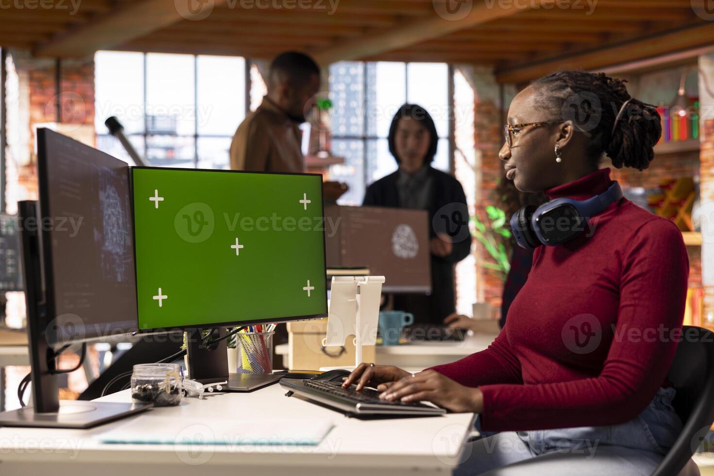 Green screen PC in workspace used by AI researcher working with artificial intelligence technology. Chroma key computer monitor used by employee developing AI systems in tech startup photo