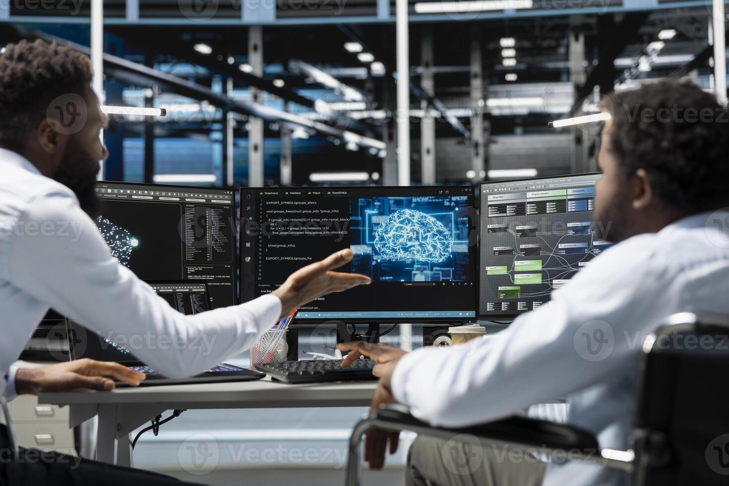 Man in wheelchair and coworker setting up data center gear needed to run artificial intelligence and machine learning. IT expert with disability and colleague in inclusive server room using AI tools photo