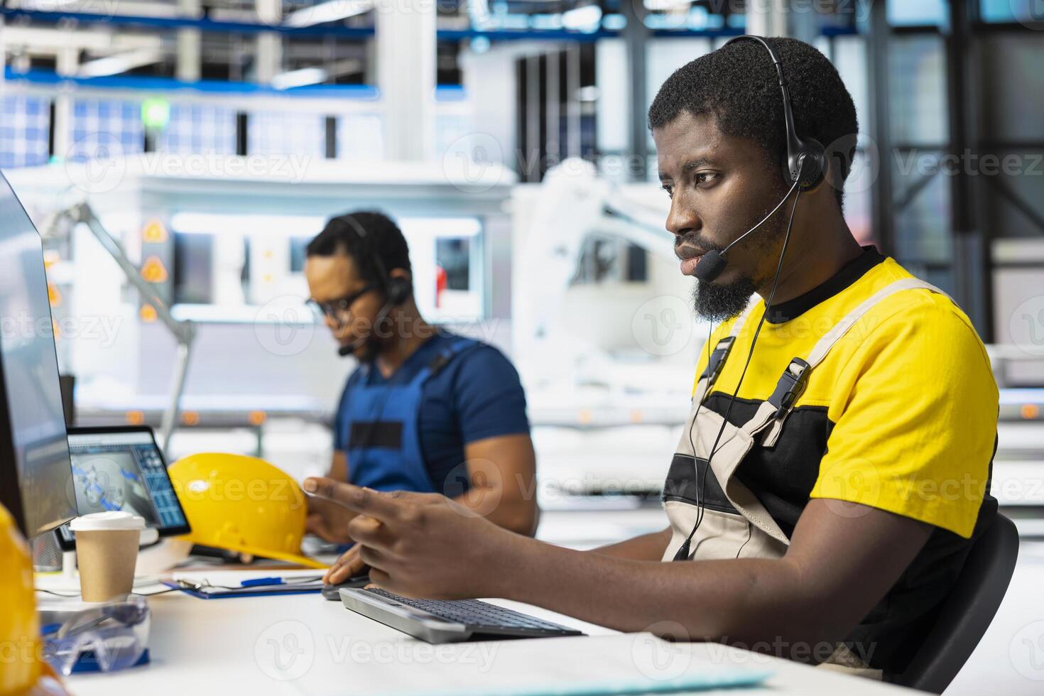 Customer support black technician on helpline in photovoltaic facility answering calls on headset, offering assistance and support in fixing technical issues. Male operator at help desk. photo