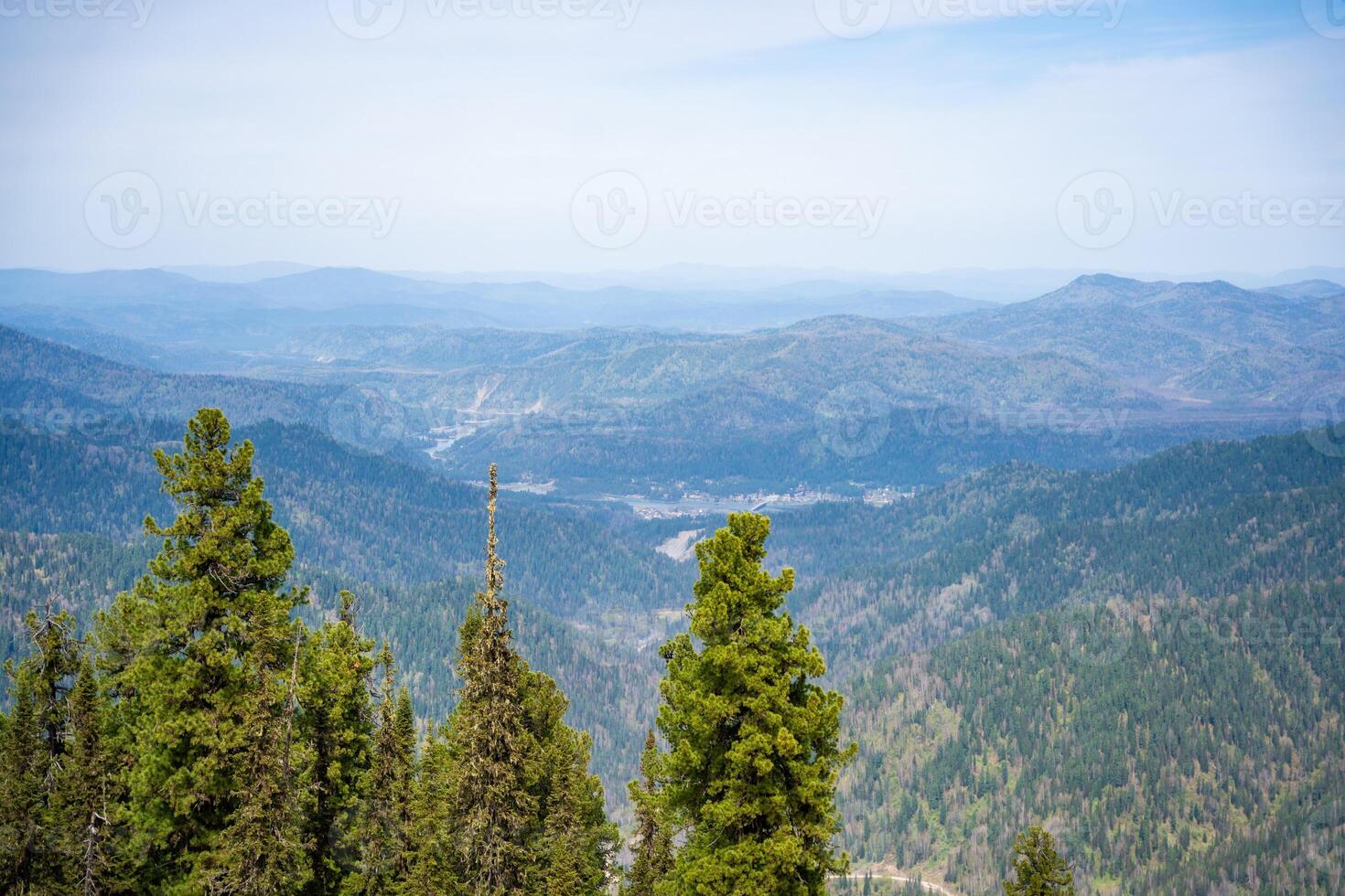 Panoramic view from Mount Kokuya at Teletskoye Ski Resort. Spring landscape with snow and mountains in Altai, Russia. High quality photo