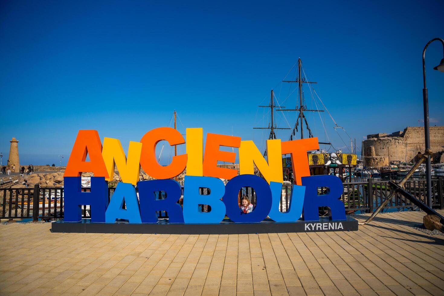Girne, Northern Cyprus - January 26, 2025. Ancient Harbour Kyrenia sign at the historic port of Kyrenia in Northern Cyprus. Medieval fortress and maritime scenery, blending history and modern tourism. photo