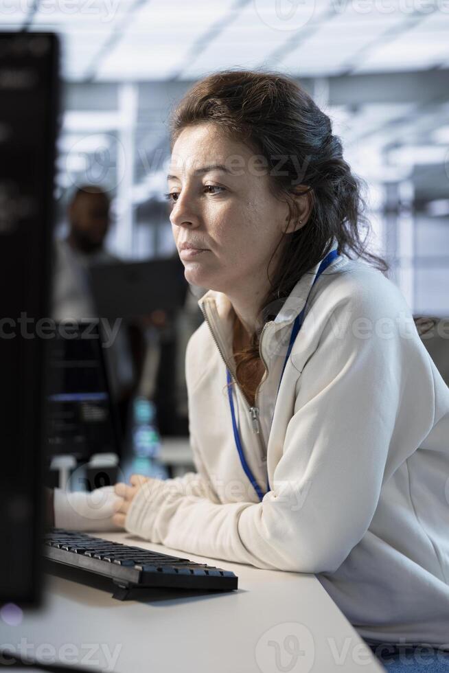 System administrator in server hub implementing power management solutions to reduce energy consumption. Employee integrating new technologies and systems in data center facility photo