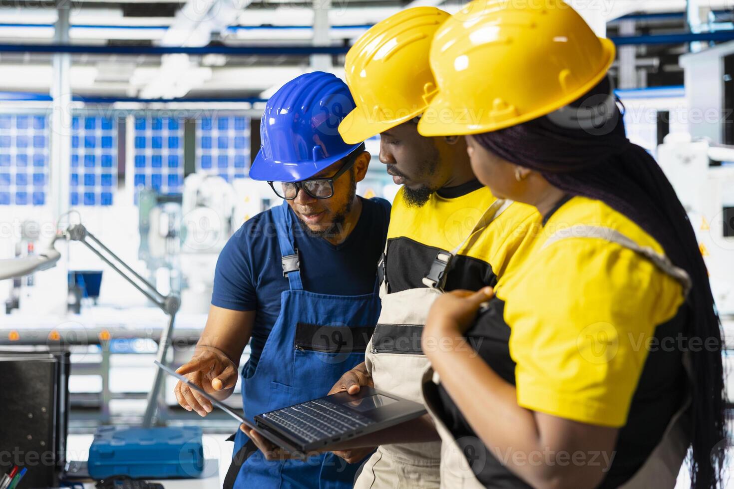 Photovoltaics plant team reviewing solar panels manual production, monitoring the performance on computer program. Black supervisors reading robotic arms machinery parameters. photo