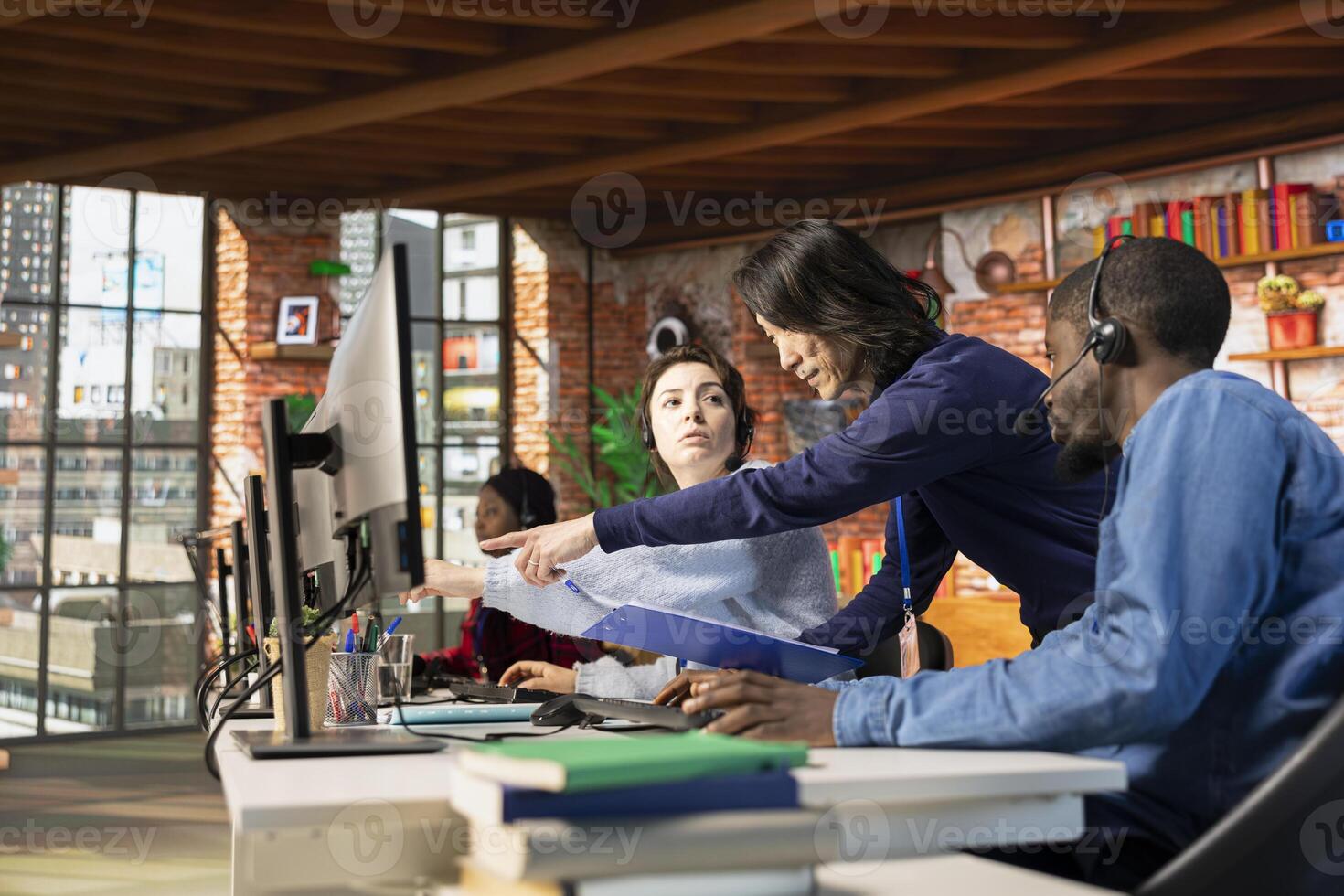 Call center manager evaluating multiethnic team performance by judging customers satisfaction. Customer service department supervisor overseeing multiracial coworkers technical onboarding photo