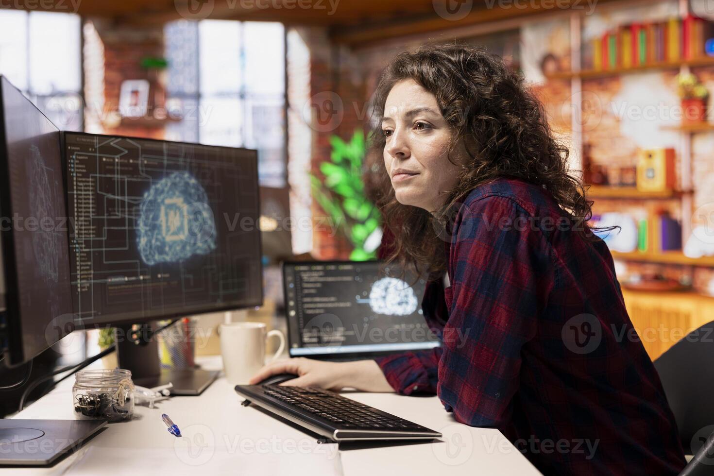 System administrator working in AI tech agency providing custom software development services. IT staff member using artificial intelligence technology to streamline coding process in startup office photo