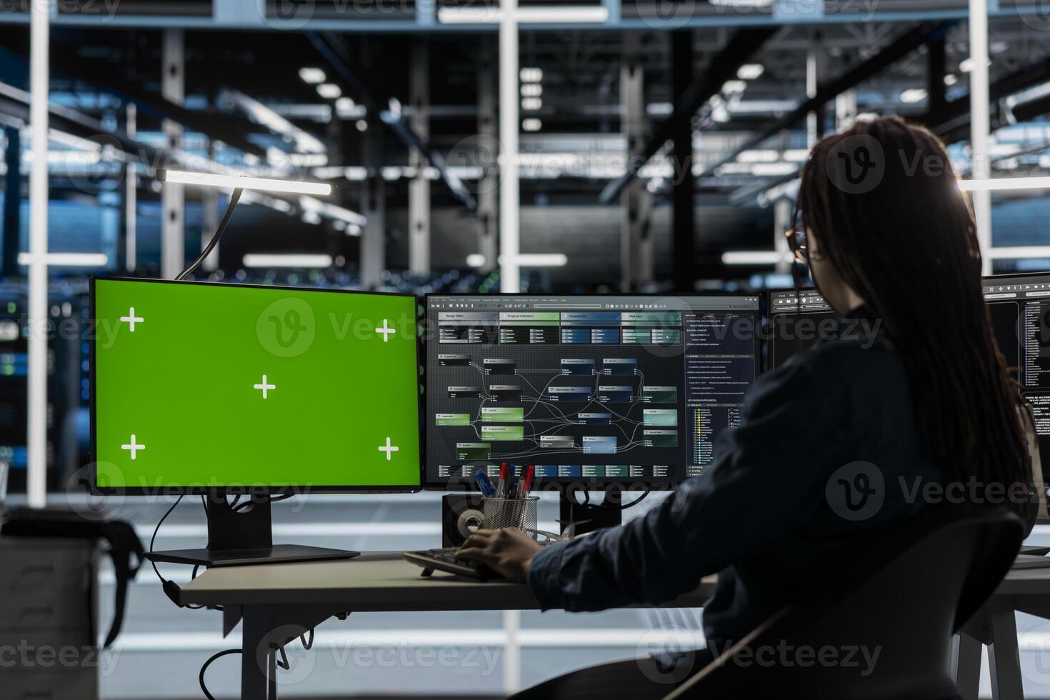 Server room technician using artificial intelligence tech on green screen PC to reduce downtime. Admin using chroma key computer to design and implement AI driven solutions for data center equipment photo