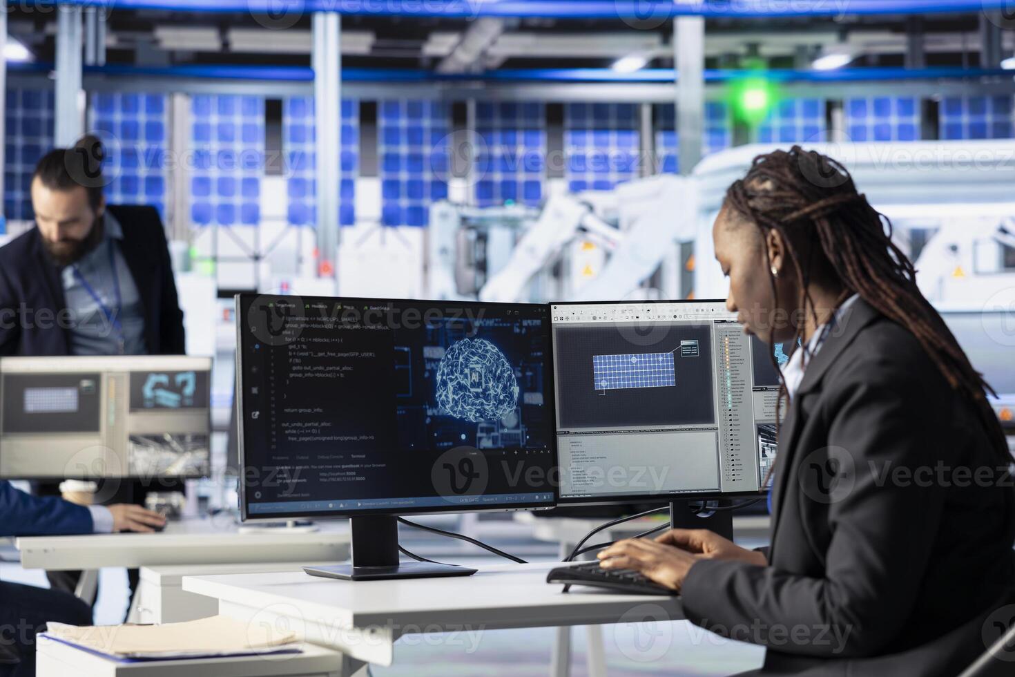 Factory worker writing AI code at workstation in photovoltaic plant, creating predictive maintenance tools. Engineer using artificial intelligence to analyze production patterns and do improvements photo