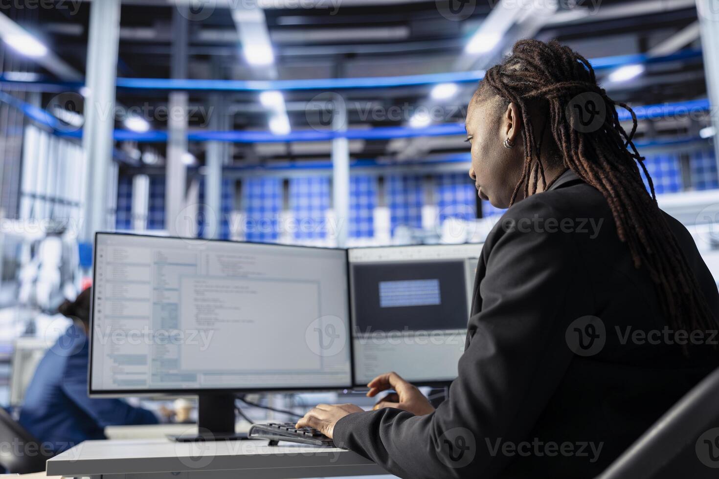 Engineer coding at workstation in solar panel manufacturing plant, developing programs to automate equipment processes. Photovoltaics factory expert writing scripts to optimize robotic operations photo