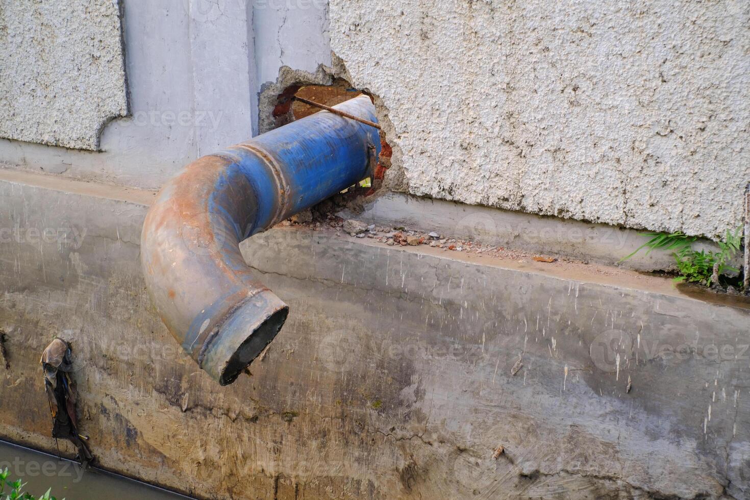 Round iron pipe for drainage above the gutter. Waste drainage from a factory built in the area outside the factory area. Hazardous waste management. Health, Safety and Environment. Copy space photo