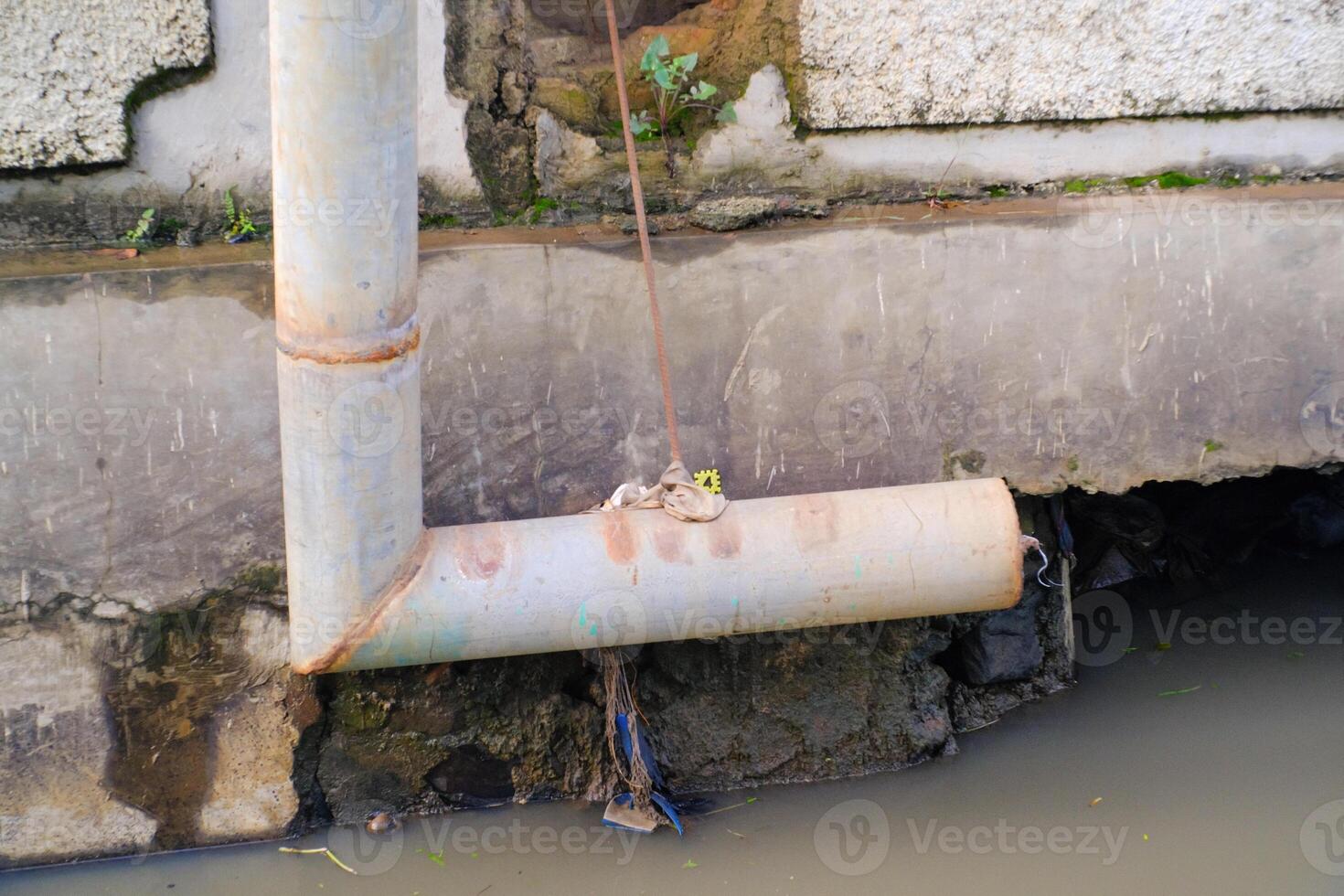 L-shaped iron pipe for drainage above the gutter. Waste drainage from a factory built in the area outside the factory area. Hazardous waste management. Health, Safety and Environment photo