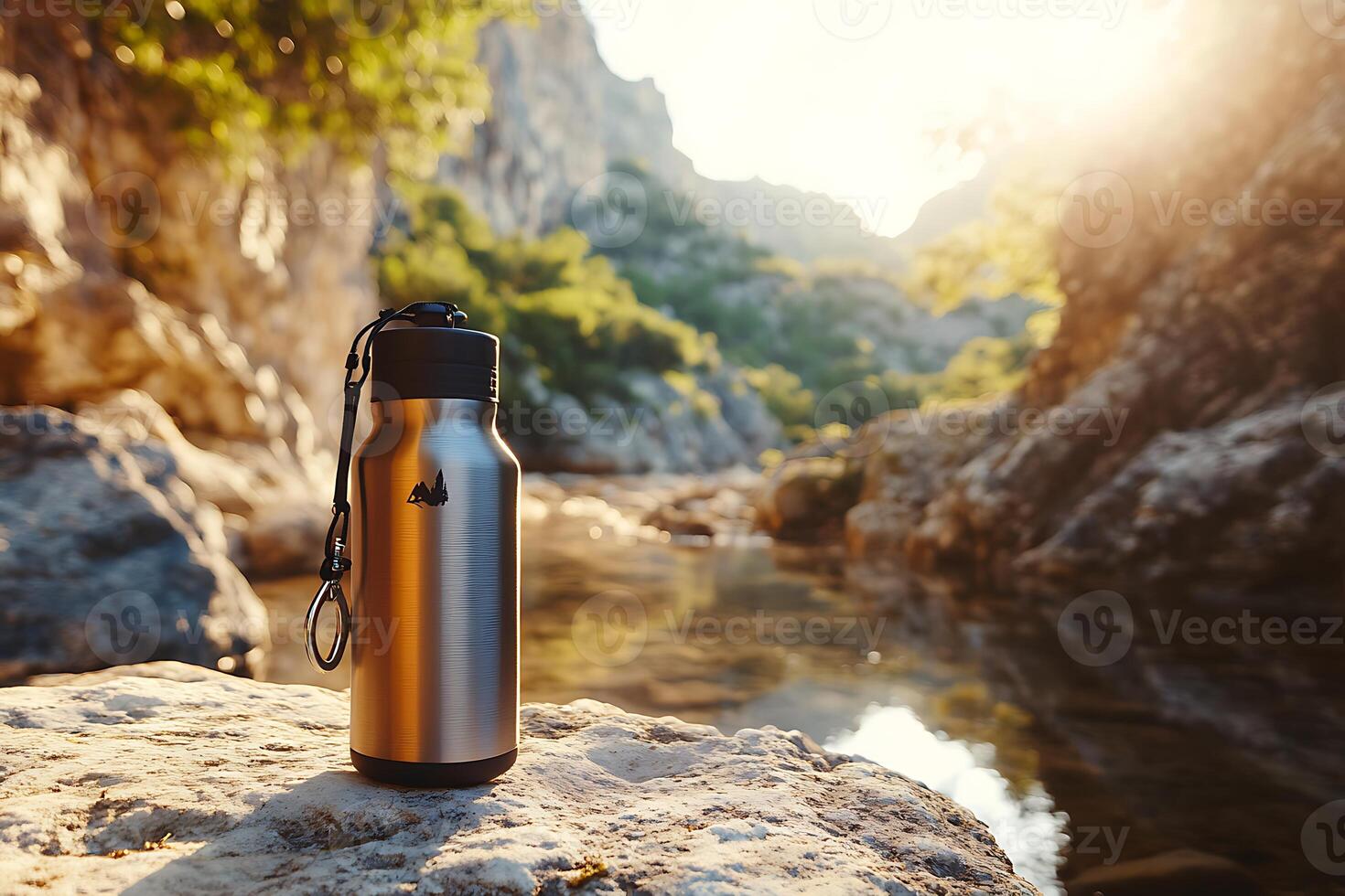 A water bottle sitting on a rock near a river photo