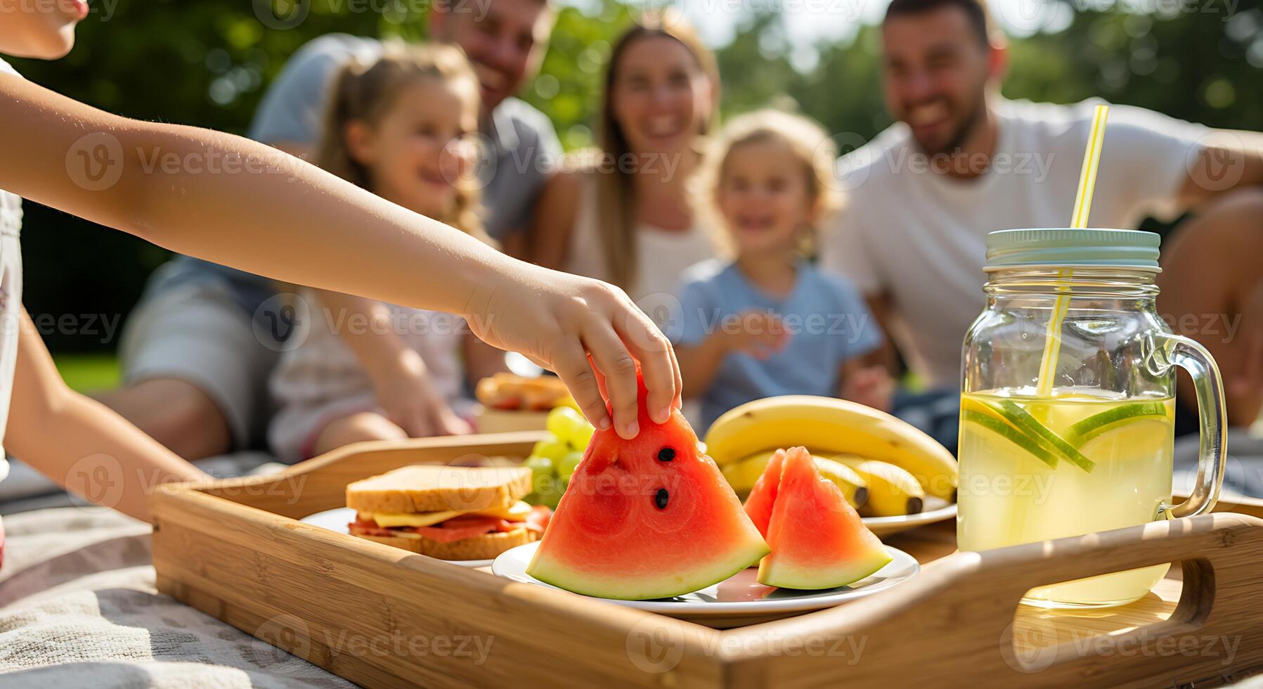Child Hand Reaching for Watermelon at Family Picnic in Sunny Backyard photo