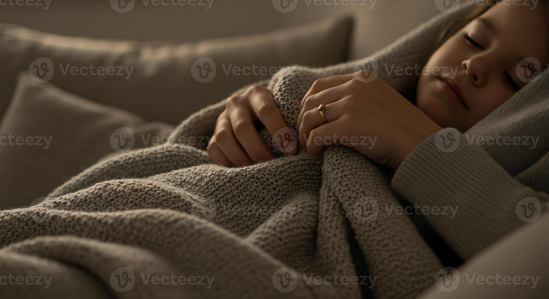 Mother Covering Child with Soft Blanket on Cozy Sofa, Family Togetherness, Comfort, Warmth, and Love in Home Setting photo