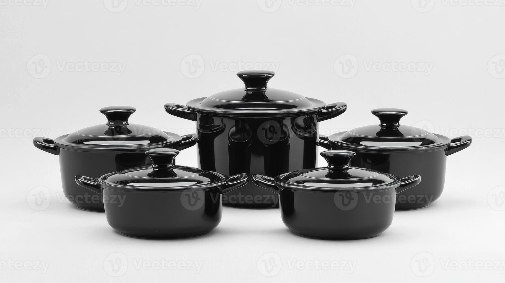 Five black ceramic cookware pieces arranged together showcasing their elegant design and functionality in a minimalist style photo