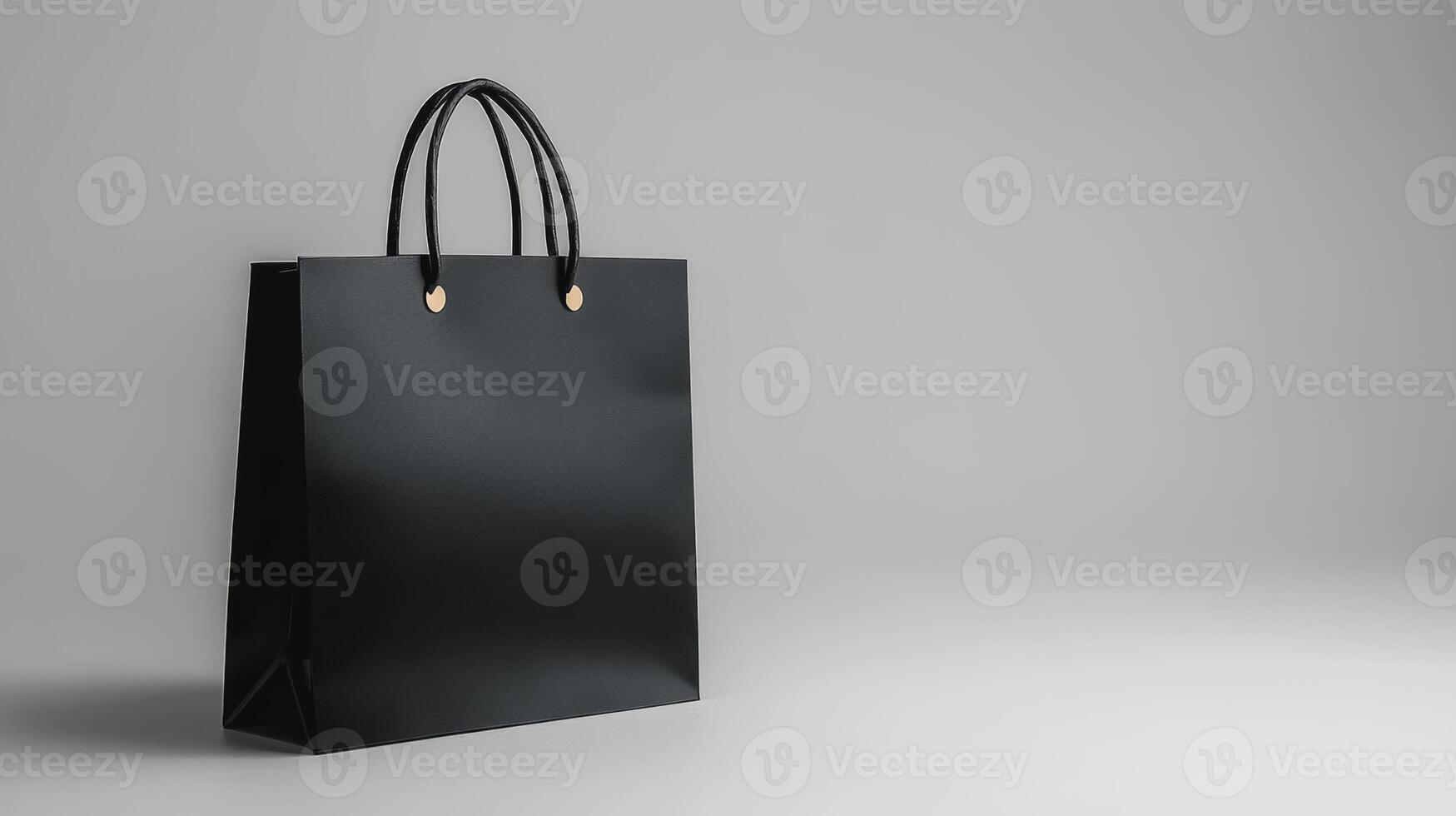 Black shopping bag on a light grey background showcasing minimal design photo