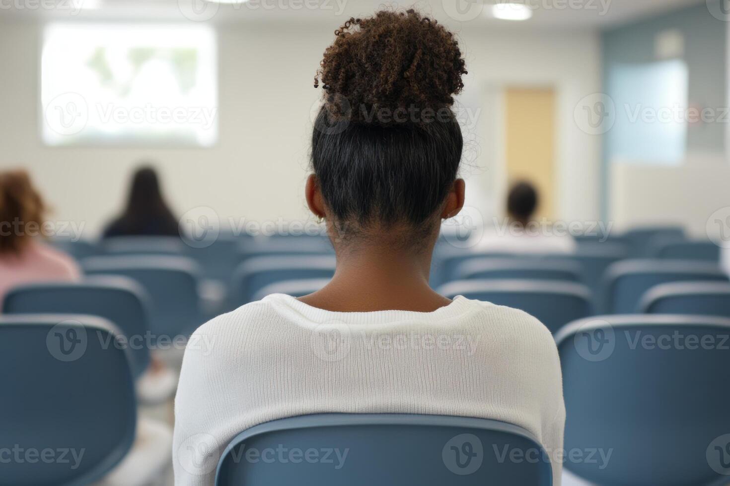 Student attending a lecture in a modern classroom focused on learning and technology photo