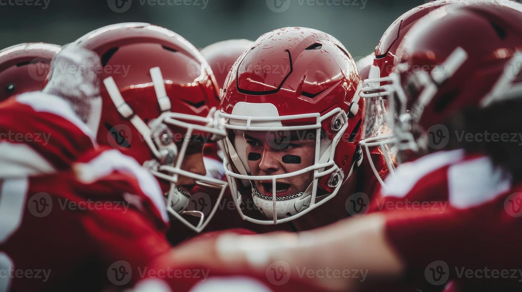 Intense football huddle during game preparation under cloudy skies in the fall season photo