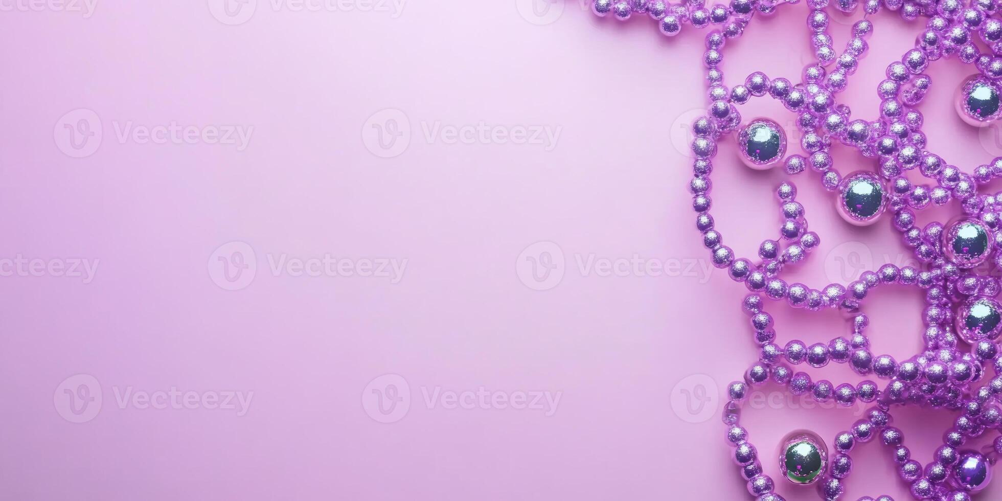 Colorful purple beads with reflective spheres create a vibrant decorative arrangement on a soft pink background photo