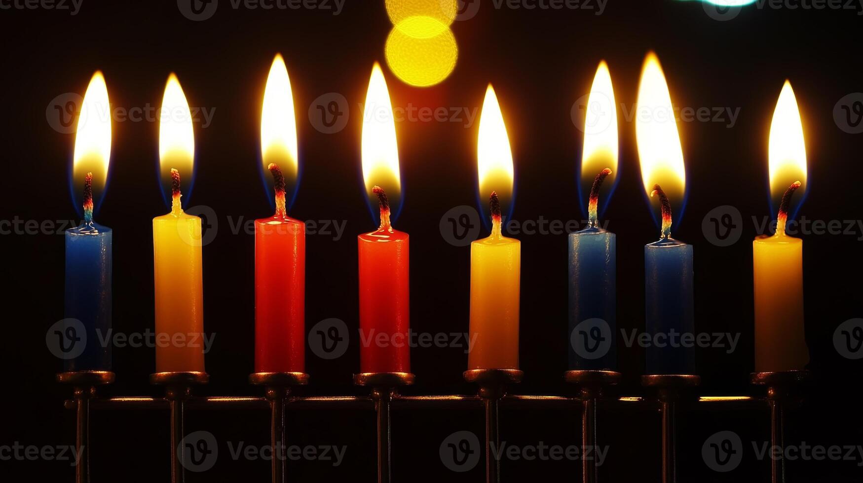 Colorful candles illuminating a festive menorah during a celebration of Hanukkah at night photo