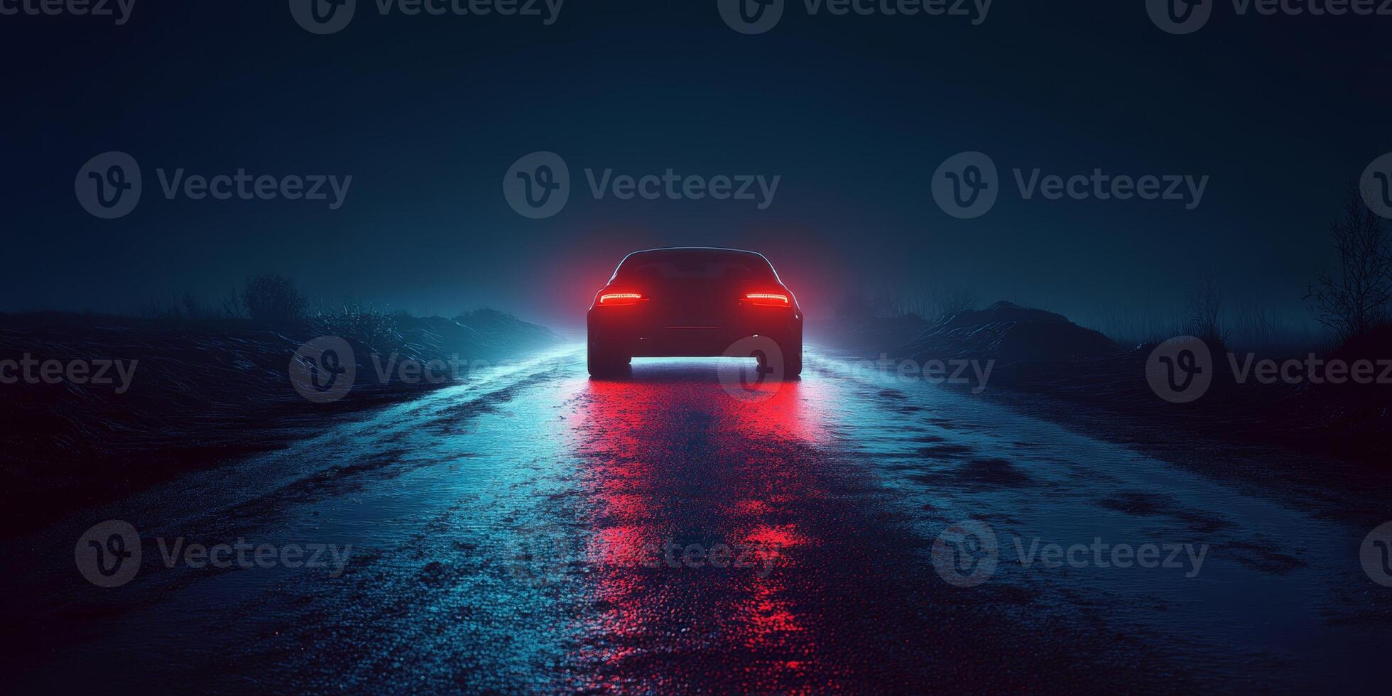 Car illuminated by red lights driving on a wet road at night with fog and dark surroundings photo