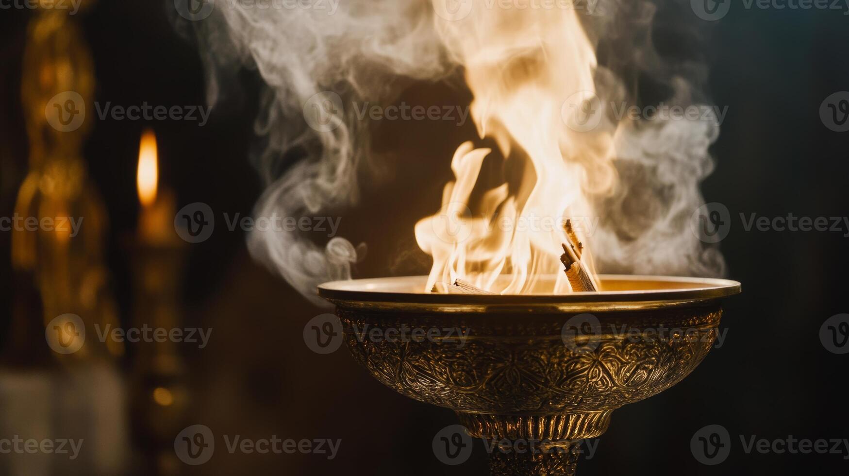 Unique ceremony featuring a flame in an ornate bowl surrounded by smoke and soft candlelight at twilight photo