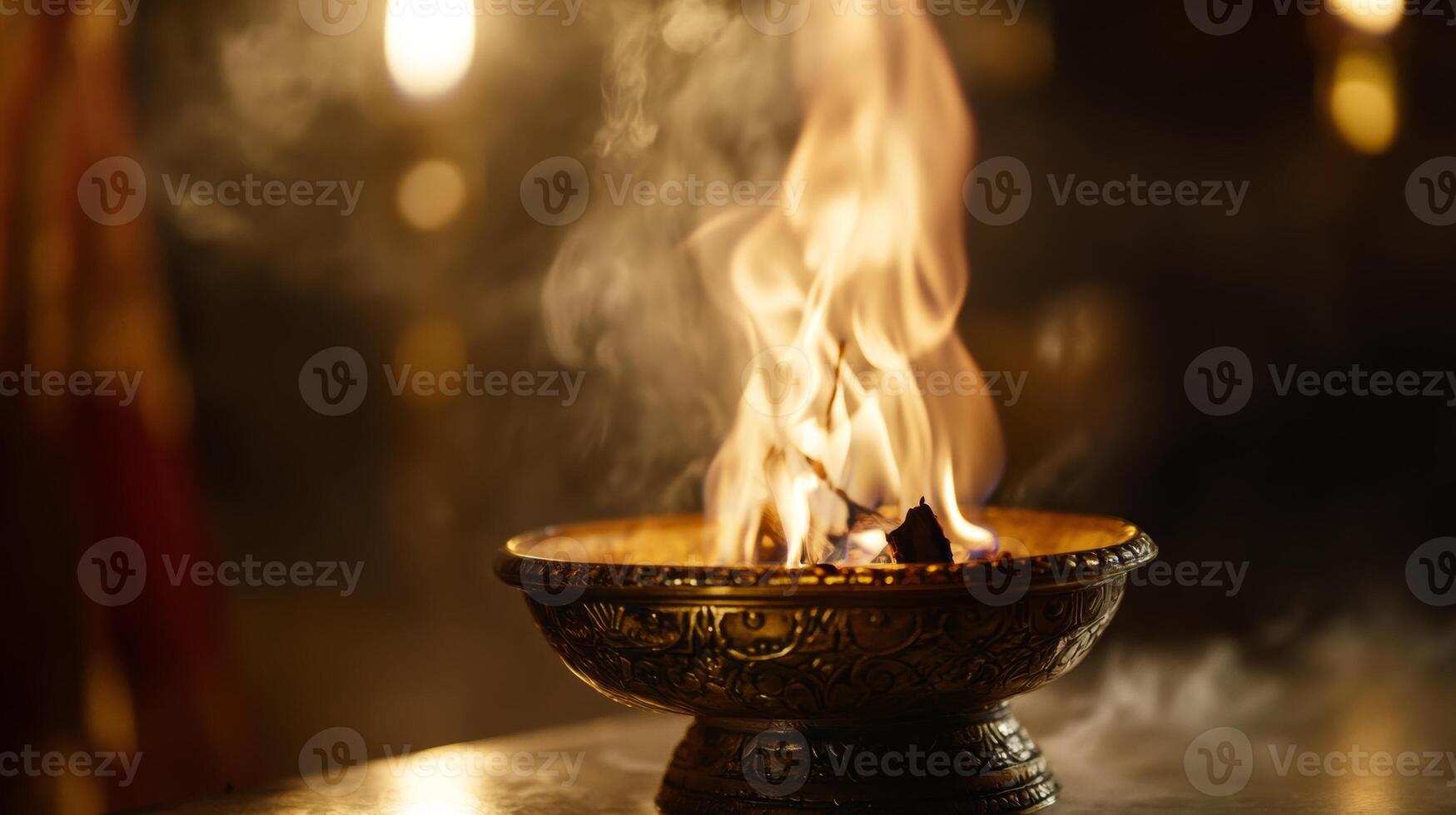 Beautiful flame dances in traditional bowl during spiritual ceremony at dusk in serene setting photo