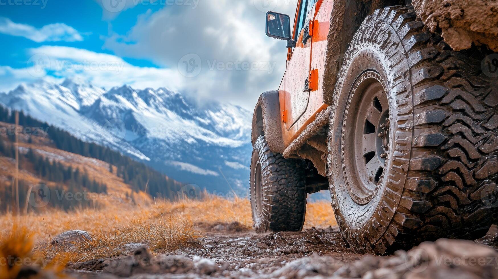 Off-road adventure with a rugged vehicle navigating a mountainous terrain under a bright sky photo