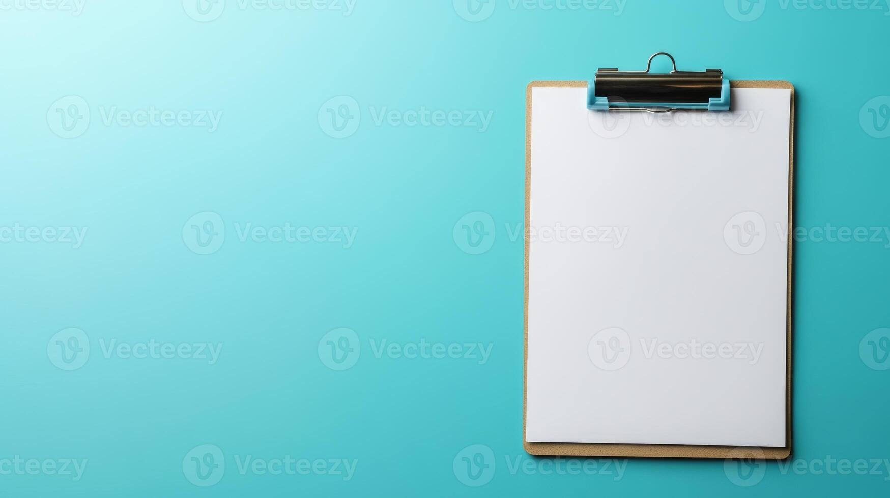 Blank clipboard ready for notes or drawings against a bright teal backdrop in a clean workspace photo