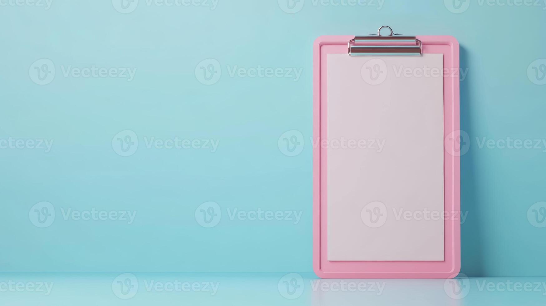 Clipboard with blank sheet against a light blue wall ready for notes or sketches photo