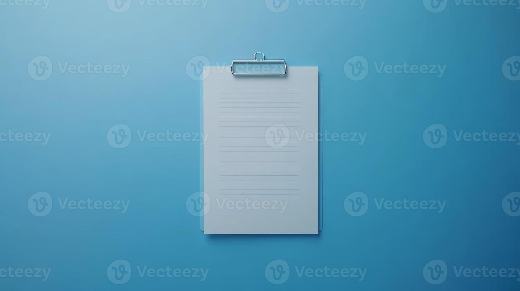 Blank clipboard with lined paper on a blue background for notes and organization tasks photo