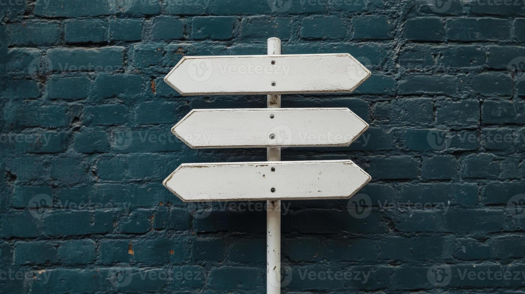 Directional signpost standing against a textured blue brick wall during daytime, showcasing multiple options for navigation and exploration photo