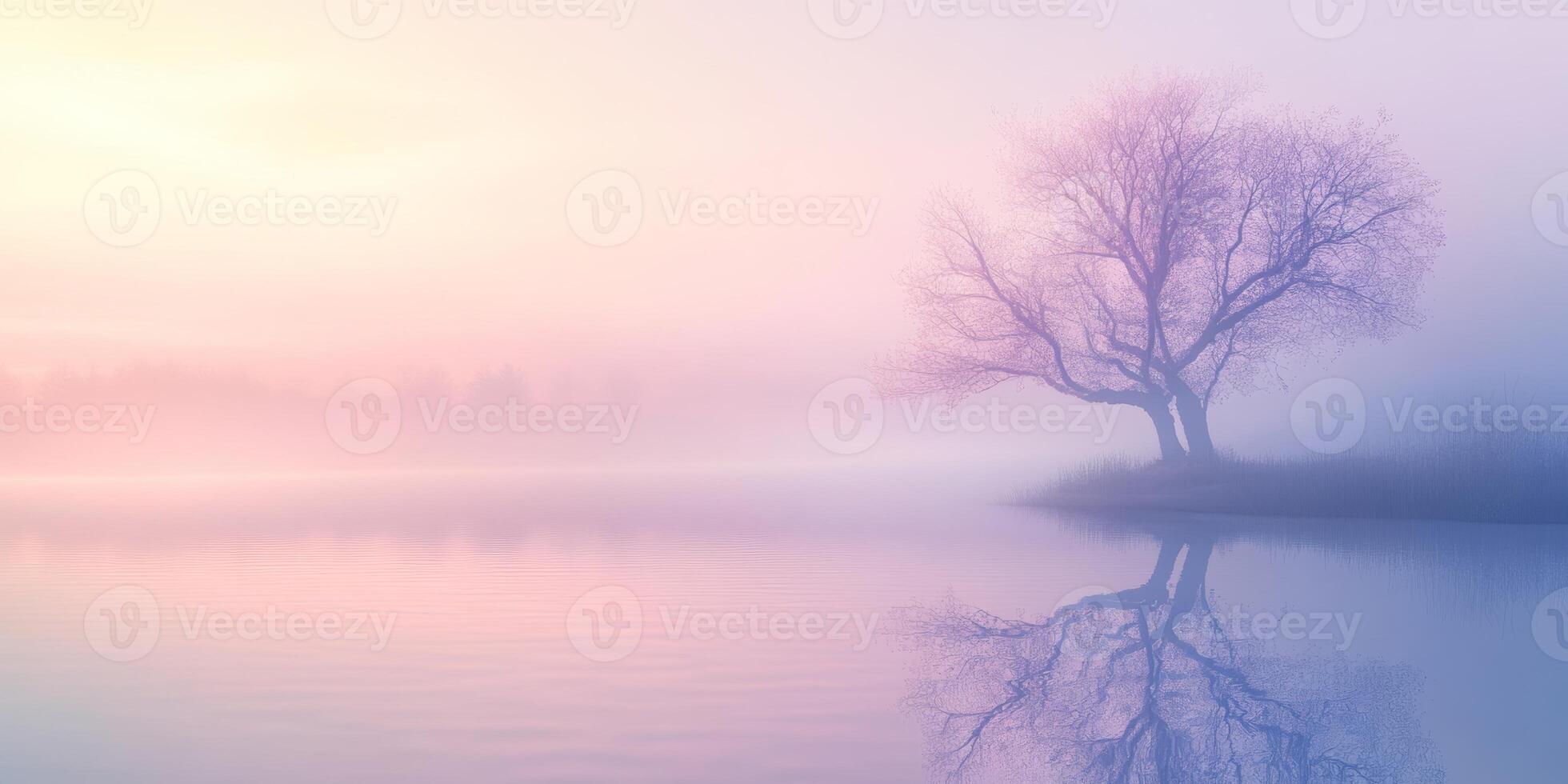 Misty sunrise over a calm lake with a solitary tree reflecting on the water photo