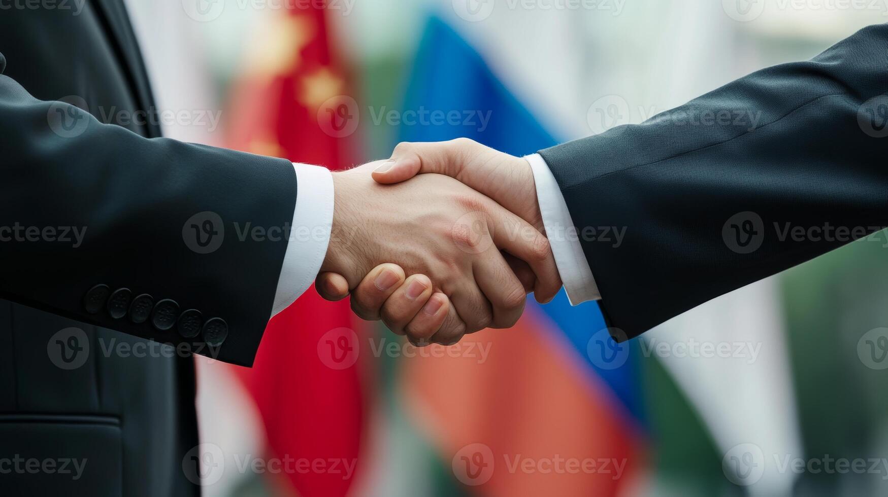 Handshake between representatives of Russia and China in front of national flags during diplomatic meeting in 2023 photo