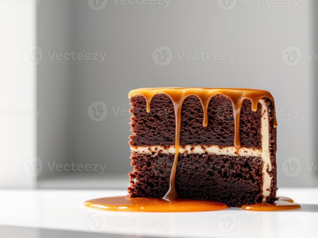 Decadent Chocolate Cake Slice Topped with Caramel Sauce, A Tempting Sweet Treat photo