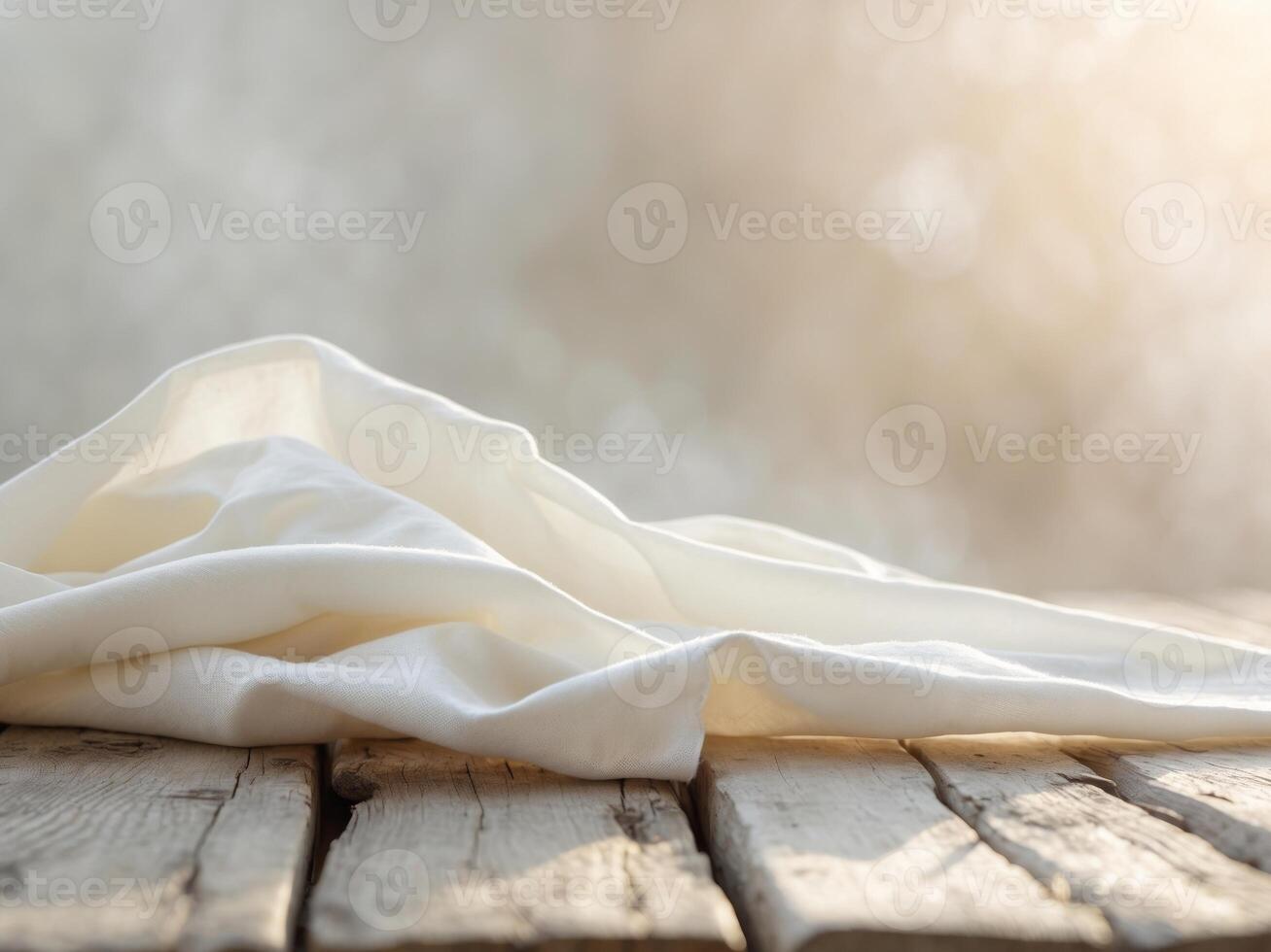 Rustic Wood Table with Cream Fabric and Blurred Light Background Closeup View. photo