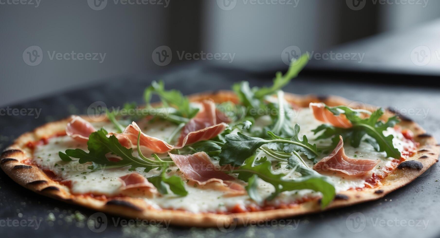 Delicious Pizza with Prosciutto, Mozzarella and Fresh Arugula on a Dark Surface. photo