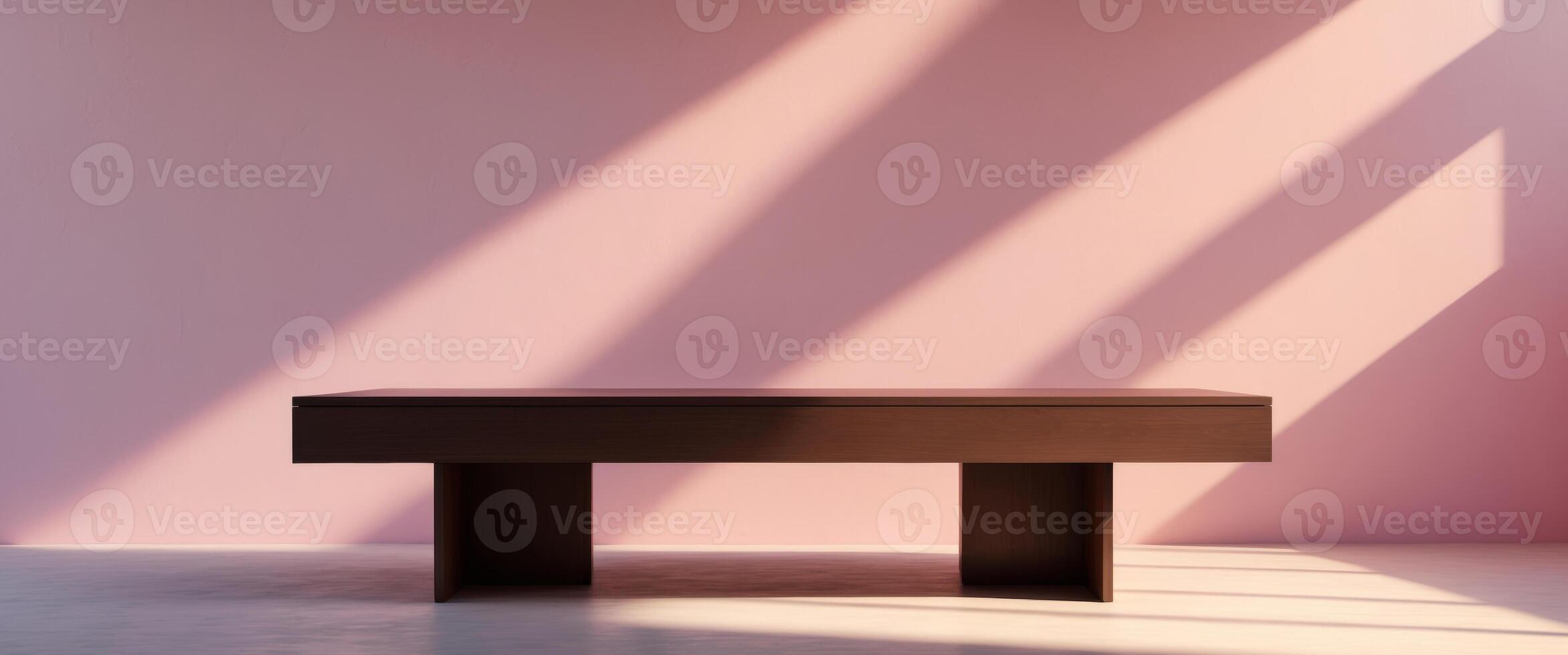 Table in front of pink wall with sunlight photo