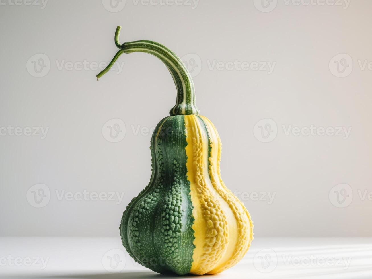 A green and yellow gourd is sitting on a table photo