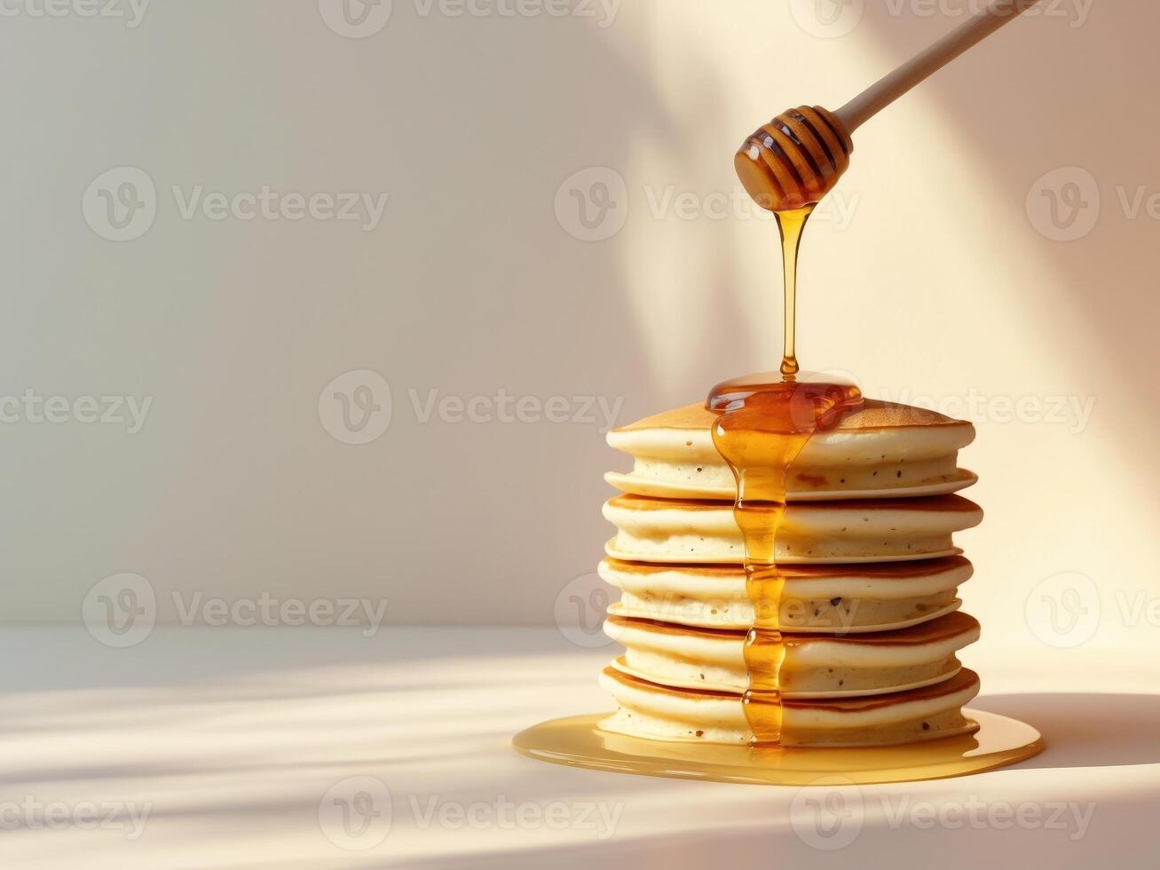 A stack of pancakes with honey drizzled on top photo