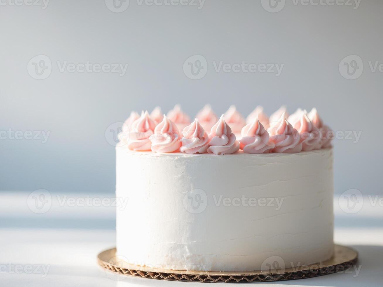 A white cake with pink frosting on top photo