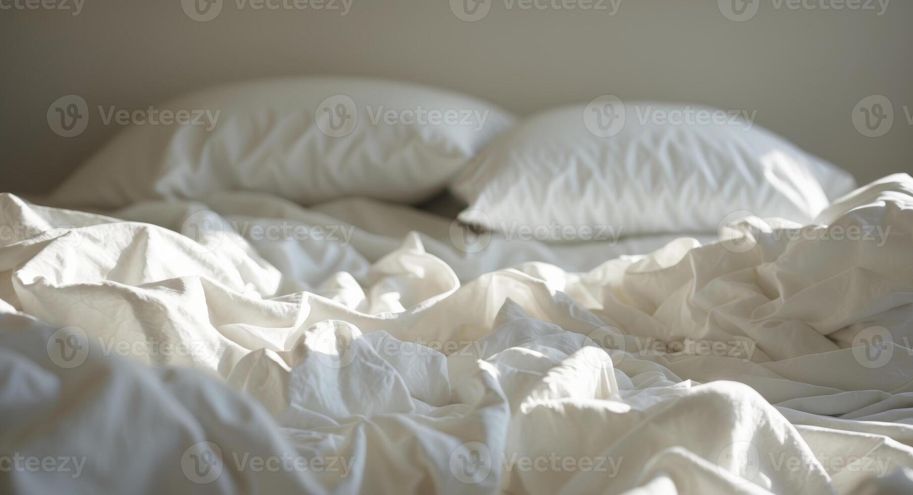 An unmade bed with pillows and sheets photo