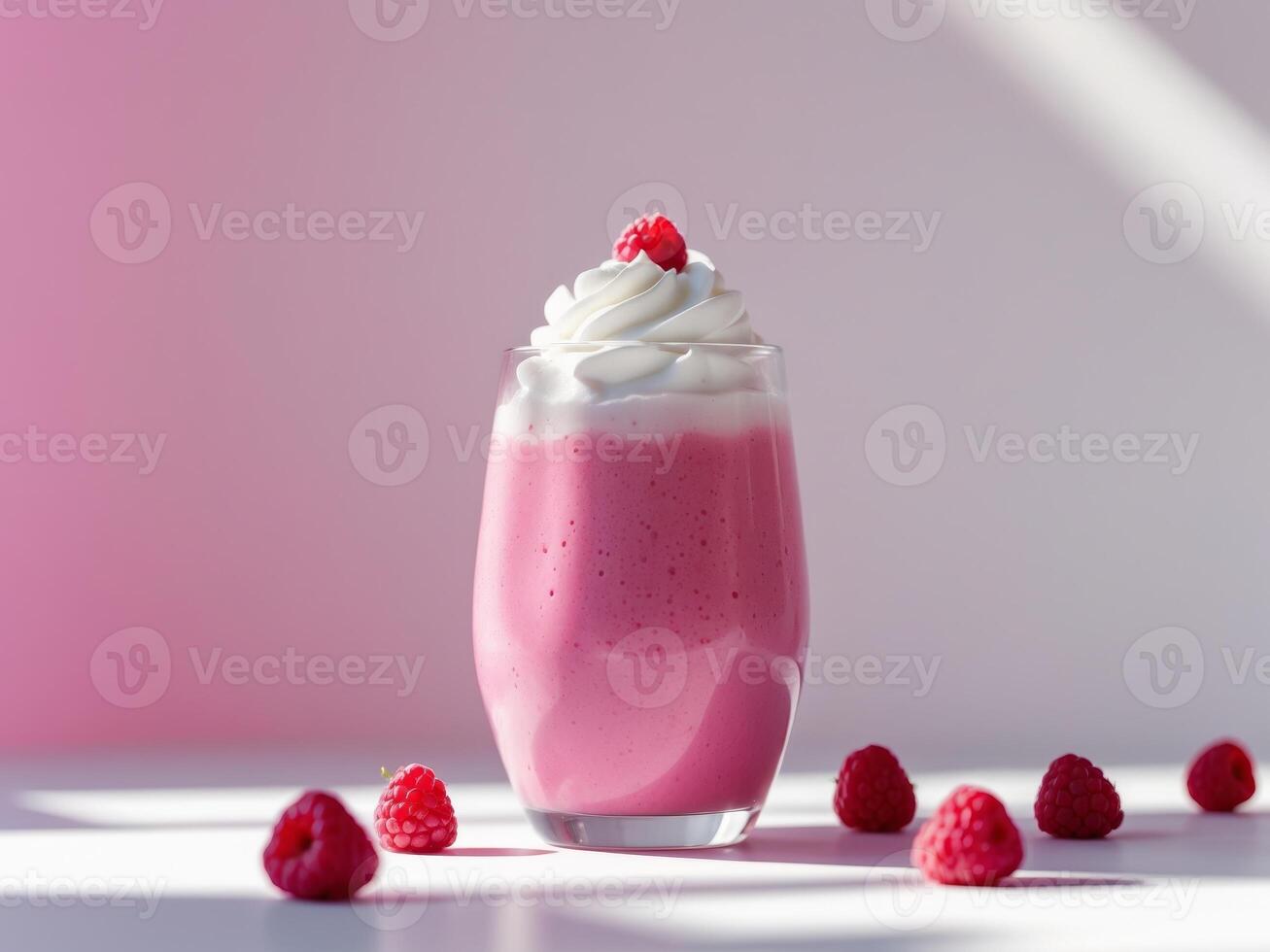 A pink smoothie with whipped cream and raspberries photo