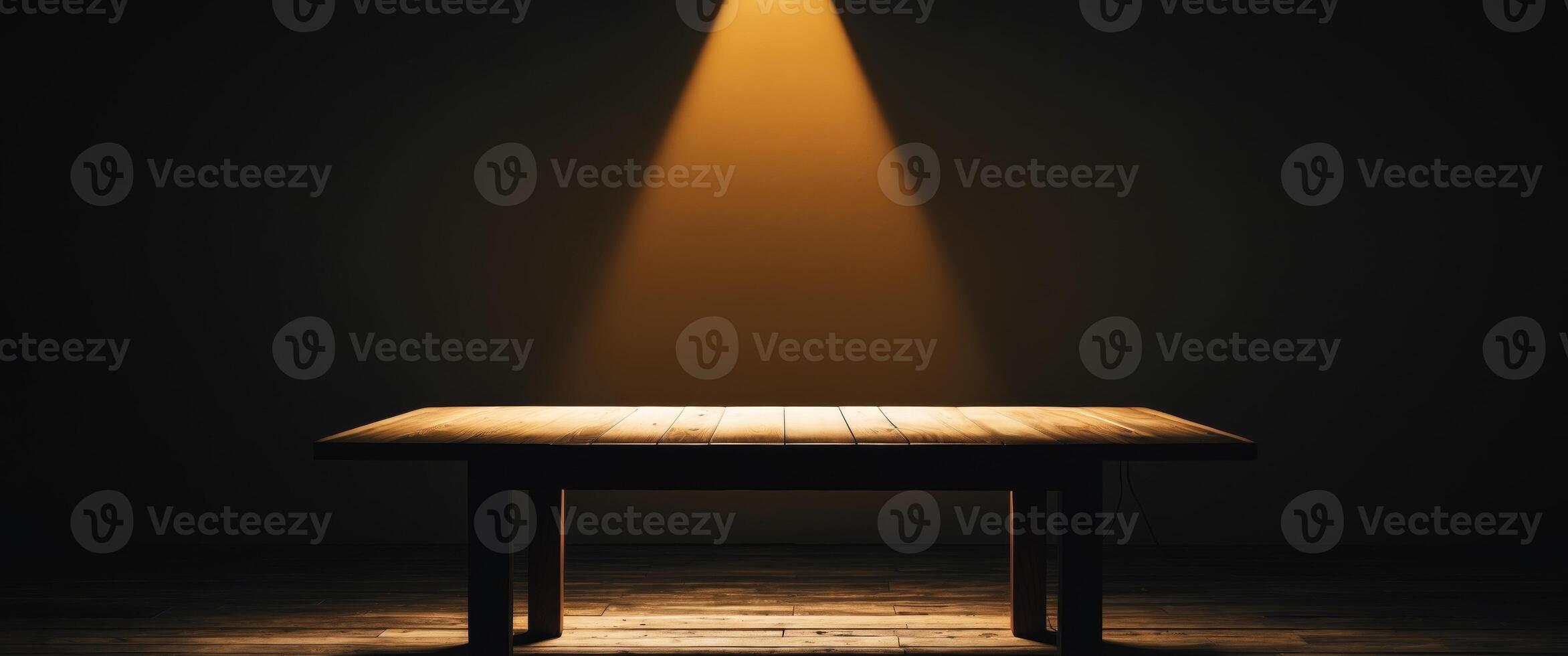 An empty table in a dark room with a spotlight shining on it photo