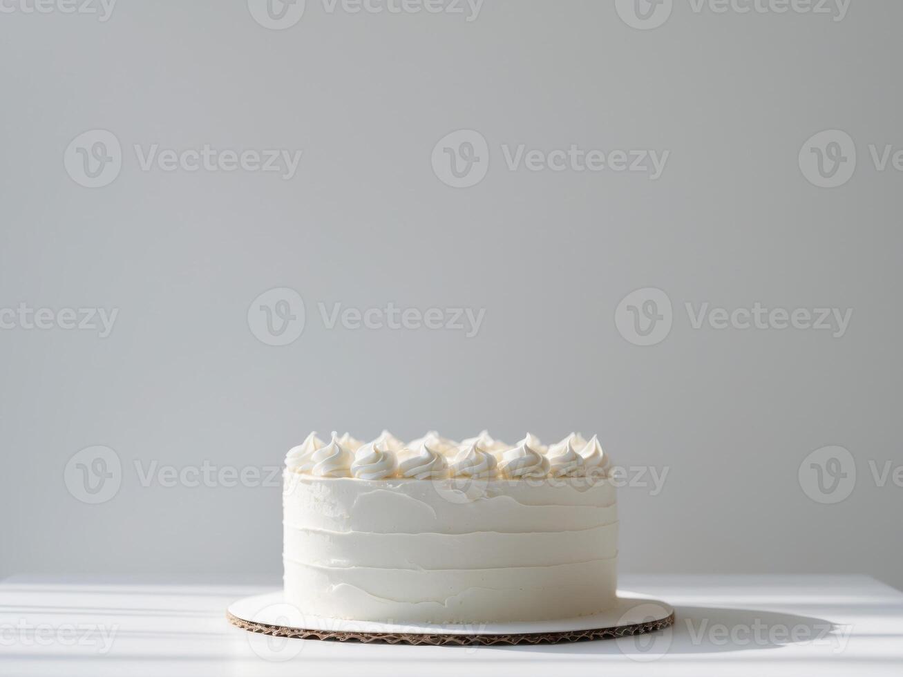 Minimalist White Cake with Creamy Frosting on a White Table, Light and Airy. photo