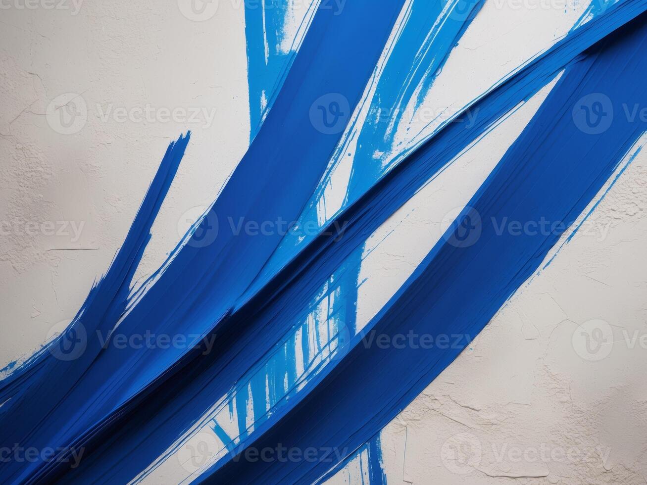 A blue paint brush is painted on a wall photo