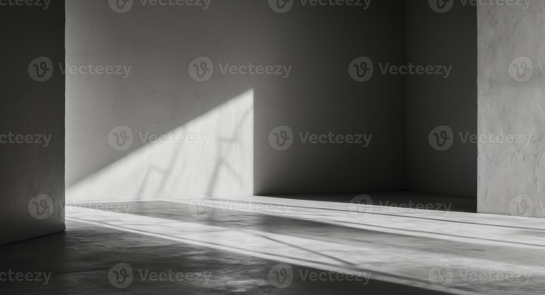 A black and white photo of a room with a window