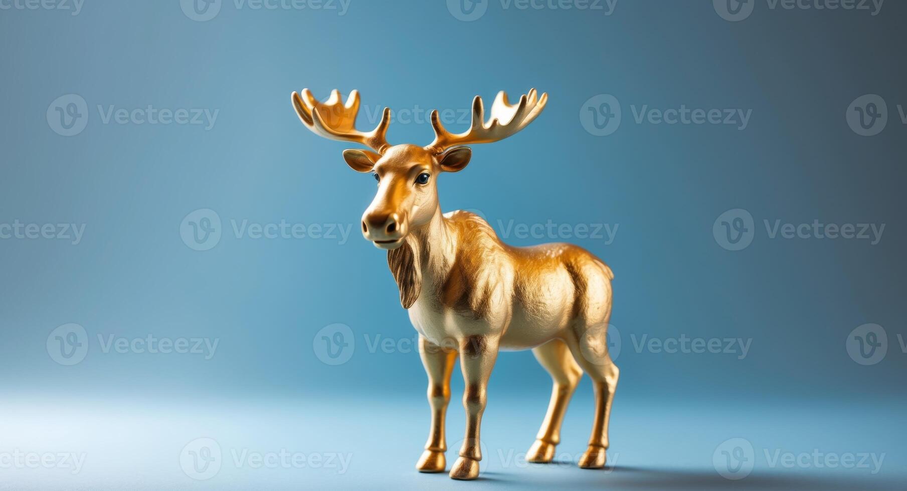 Golden Moose Figurine on Blue Background, Static Composition, Decorative Object. photo