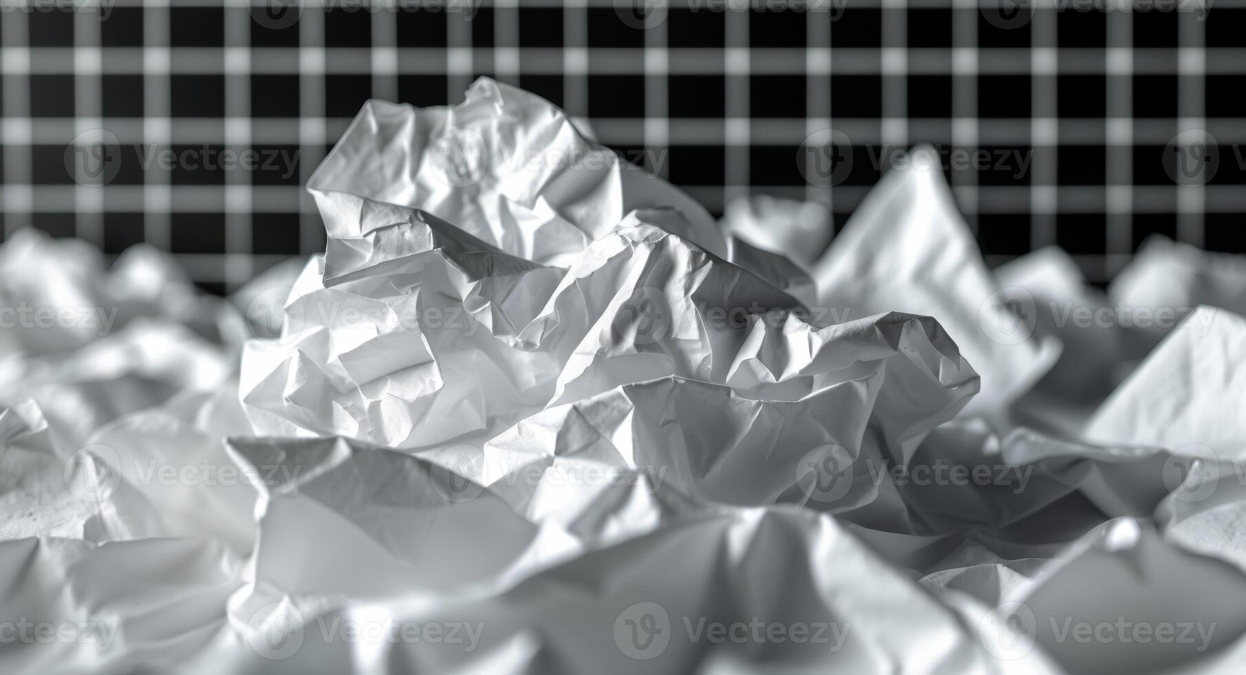 Crumpled White Paper Chaos on a Black and White Checkerboard Background Studio Shot. photo